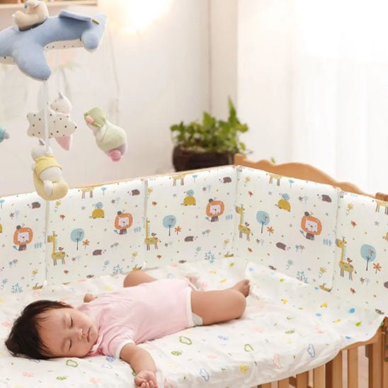 Tour de lit bebe Douceur kaki avec un bébé qui dort dans un berceau